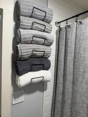 a stack of towels on a towel rack in a bathroom at Modern Stay in Downtown Jersey City, Close to NYC! in Jersey City