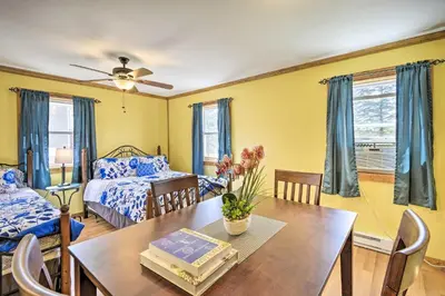 a living room with a table and a bed at Quadruple Suites At Equestrian House in Pleasant Mount