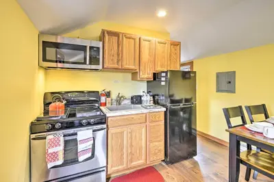 a kitchen with a stainless steel stove and refrigerator at Romantic Escape Cottage and Suites Close to Ski Trails in Pleasant Mount