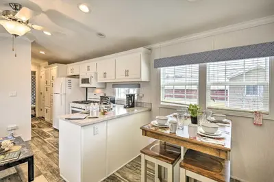 a kitchen with white cabinets and a counter top at Romantic Escape Cottage and Suites Close to Ski Trails in Pleasant Mount