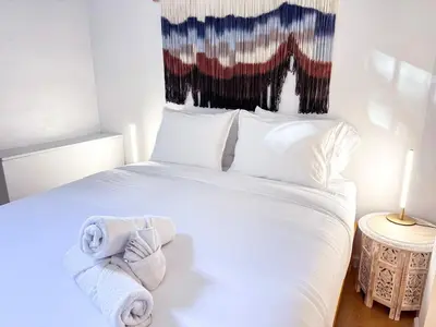a bedroom with a white bed with towels on it at Residence Heritage Giant 3 Bedroom in New York