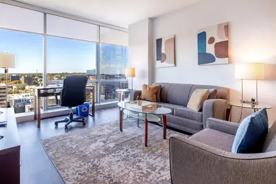 a living room with a couch and a table at Luxury Apartment in Stamford - Gym & Pool Access in Stamford