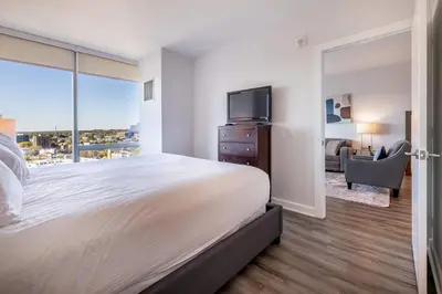 a bedroom with a large bed and a tv at Luxury Apartment in Stamford - Gym & Pool Access in Stamford