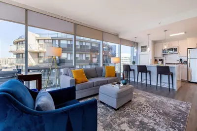 a living room with a couch and a table at Chic Stamford Apartment - Walk to Train & Entertainment in Stamford