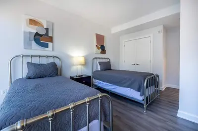a bedroom with two beds and a window in it at Chic Stamford Apartment - Walk to Train & Entertainment in Stamford