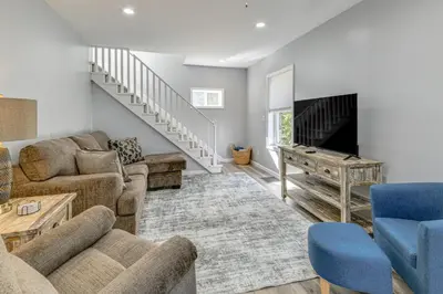 a living room with a couch and a piano at Walk to Main Street! Updated Norwich Home in Norwich