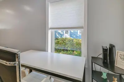 a white table in a room with a window at Walk to Main Street! Updated Norwich Home in Norwich