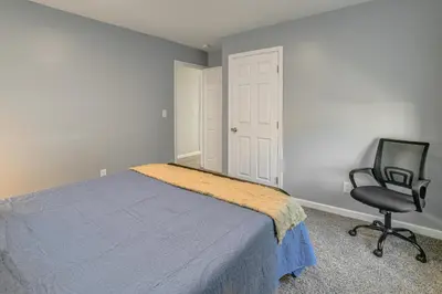 a bedroom with a bed and a chair at Walk to Main Street! Updated Norwich Home in Norwich