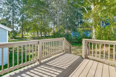 a wooden bridge leading to a yard with trees at Walk to Main Street! Updated Norwich Home in Norwich