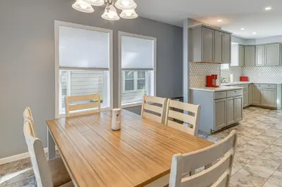 a kitchen and dining room with a wooden table and chairs at Walk to Main Street! Updated Norwich Home in Norwich