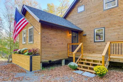 a house with an american flag on the side of it at Hike, Ski and Relax Renovated Retreat in Wilmington in Wilmington
