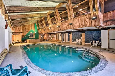 a pool in a large room with wooden walls and ceilings at Hike, Ski and Relax Renovated Retreat in Wilmington in Wilmington