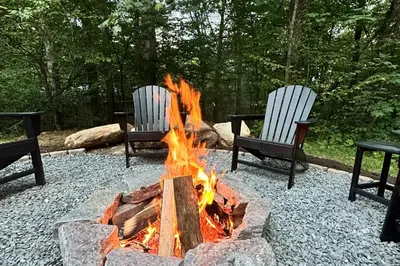 a fire pit with two chairs sitting around it at Hike, Ski and Relax Renovated Retreat in Wilmington in Wilmington