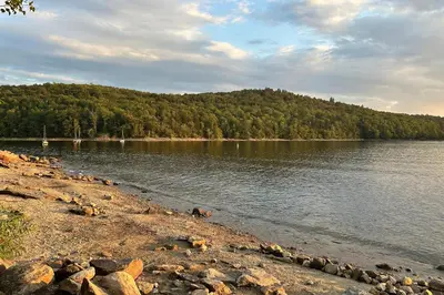 a body of water with a mountain in the background at Hike, Ski and Relax Renovated Retreat in Wilmington in Wilmington