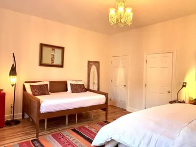 a bedroom with two beds and a chandelier at Luxurious bedroom in New York