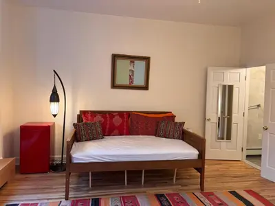 a room with a bed with pillows on it at Luxurious bedroom in New York