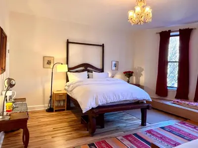 a bedroom with a large bed and a chandelier at Luxurious bedroom in New York