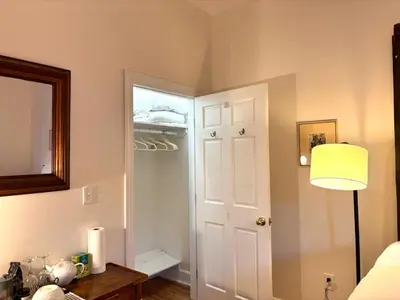 a room with a closet with a door and a lamp at Luxurious bedroom in New York