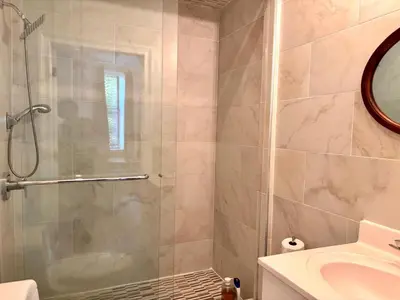a bathroom with a shower and a sink at Luxurious bedroom in New York