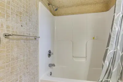 a bathroom with a white tub and a shower at Hike, Ski and Explore Otisville Retreat with Yard! in Otisville