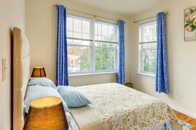 a bedroom with blue curtains and a bed at Quiet Newark Apt Near Colleges, Arenas and Hospitals in Newark