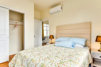 a bedroom with a large bed with blue pillows at Quiet Newark Apt Near Colleges, Arenas and Hospitals in Newark