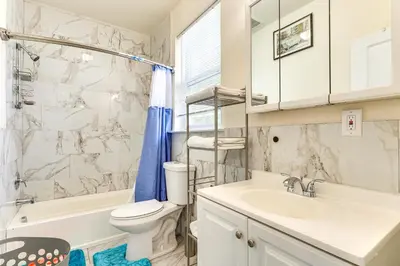 a bathroom with a sink and a toilet and a tub at Quiet Newark Apt Near Colleges, Arenas and Hospitals in Newark