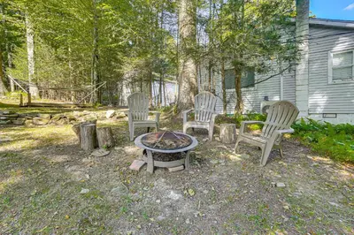a group of chairs sitting around a fire pit at Boat, Hike and Fish Rustic Greenwood Retreat in Greentown