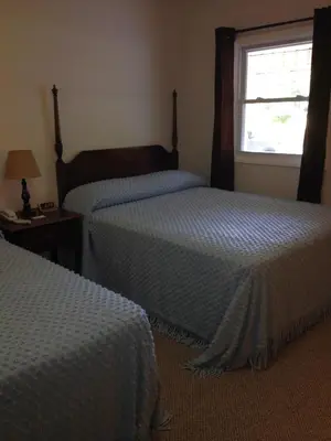 a hotel room with two beds and a window at McGregor Inn Motel in Saratoga Springs