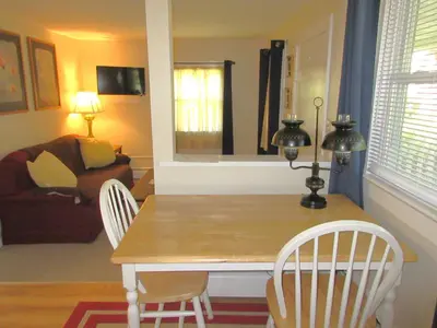 a dining room table with two chairs and a couch at McGregor Inn Motel in Saratoga Springs