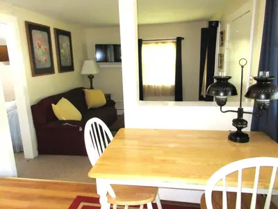 a living room with a table and a couch at McGregor Inn Motel in Saratoga Springs