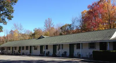 a white building with a gray roof at McGregor Inn Motel in Saratoga Springs