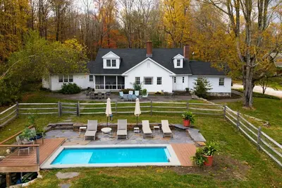 a house with a swimming pool in the yard at Elegant 7BR Estate with Pool & Hot Tub in Berkshires in North Egremont