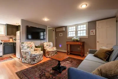 a living room with a couch and chairs and a tv at Elegant 7BR Estate with Pool & Hot Tub in Berkshires in North Egremont