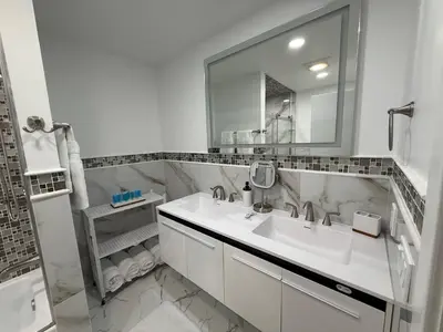 a white bathroom with a sink and a mirror at Top Luxe Oasis -Ski, Hike, Firepit, Spa, Golf in Vernon Township