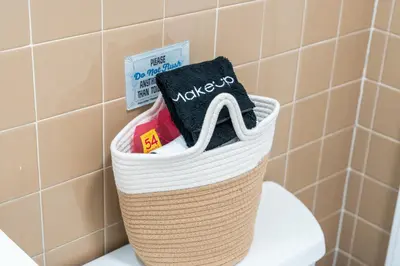 a basket on top of a toilet in a bathroom at Quiet Retreat 10 Min to NYC Train & free Parking in Bayonne