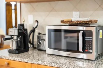 a microwave sitting on top of a kitchen counter at Quiet Retreat 10 Min to NYC Train & free Parking in Bayonne