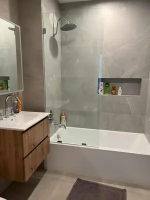 a bathroom with a tub and a sink and a shower at Brooklyn - Dumbo - 2-bedroom, 2-bath apartment in Brooklyn