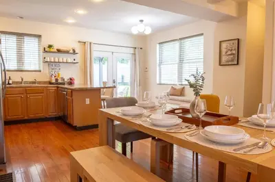 a kitchen and dining room with a table and chairs at Downtown Albany, Hot Tub, Game Room, eV Charger in Albany