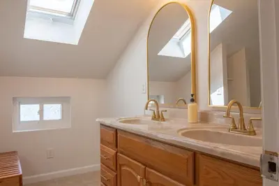 a bathroom with two sinks and a large mirror at Downtown Albany, Hot Tub, Game Room, eV Charger in Albany