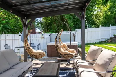 three wicker chairs and a table under a gazebo at Downtown Albany, Hot Tub, Game Room, eV Charger in Albany