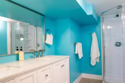 a blue bathroom with a sink and a shower at Downtown Albany, Hot Tub, Game Room, eV Charger in Albany