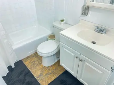 a white bathroom with a toilet and a sink at Premium convenient stays in Manchester