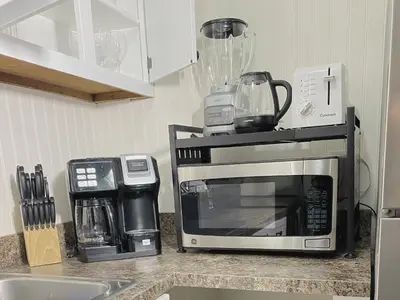 a kitchen counter with a microwave and a coffee maker at Premium convenient stays in Manchester