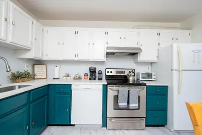 a kitchen with blue cabinets and white appliances at Outdoors, Hiking, Skiing Mountain Vacation Getaway in Tannersville