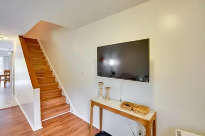 a living room with a tv on the wall and a staircase at Outdoors, Hiking, Skiing Mountain Vacation Getaway in Tannersville