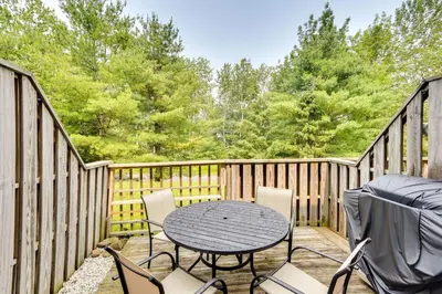 a patio with a table and chairs on a deck at Outdoors, Hiking, Skiing Mountain Vacation Getaway in Tannersville