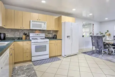 a kitchen with white appliances and a dining room at Charming Mamaroneck with 3BR and 3BA 22 Mi to Manhattan in Mamaroneck