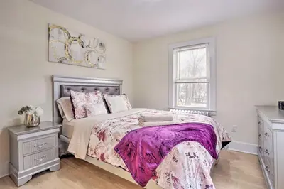 a bedroom with a large bed and a window at Charming Mamaroneck with 3BR and 3BA 22 Mi to Manhattan in Mamaroneck