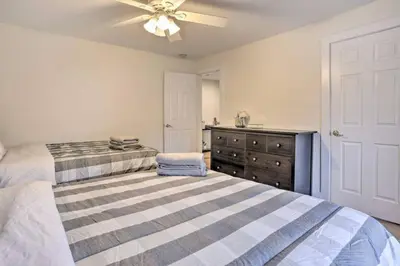 a bedroom with a bed with a ceiling fan and a dresser at Charming Mamaroneck with 3BR and 3BA 22 Mi to Manhattan in Mamaroneck